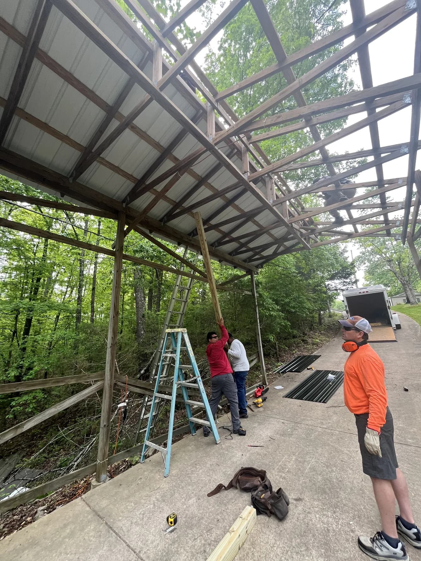 Crew working on covered porch roof framing