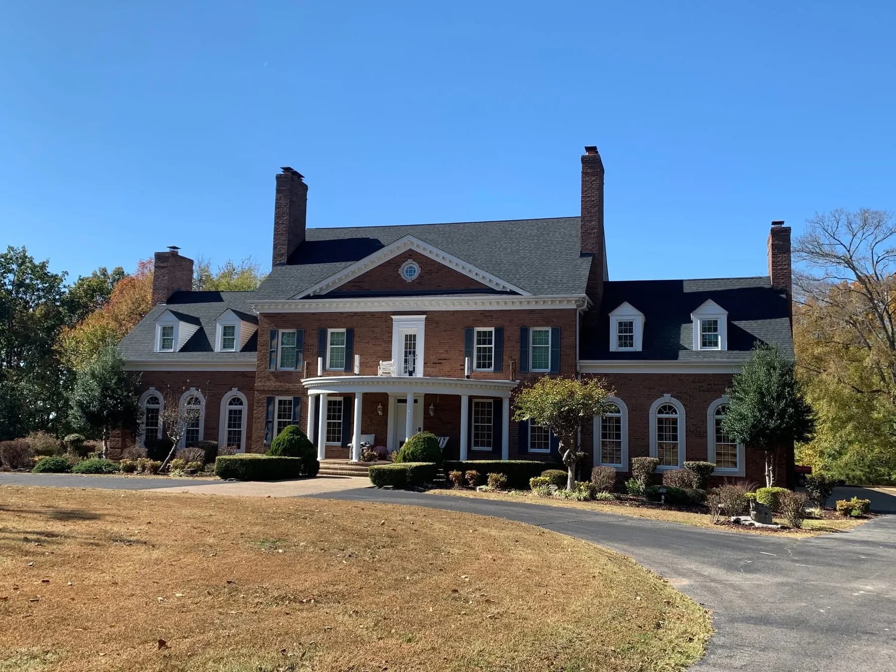 Large brick estate home with finished roof