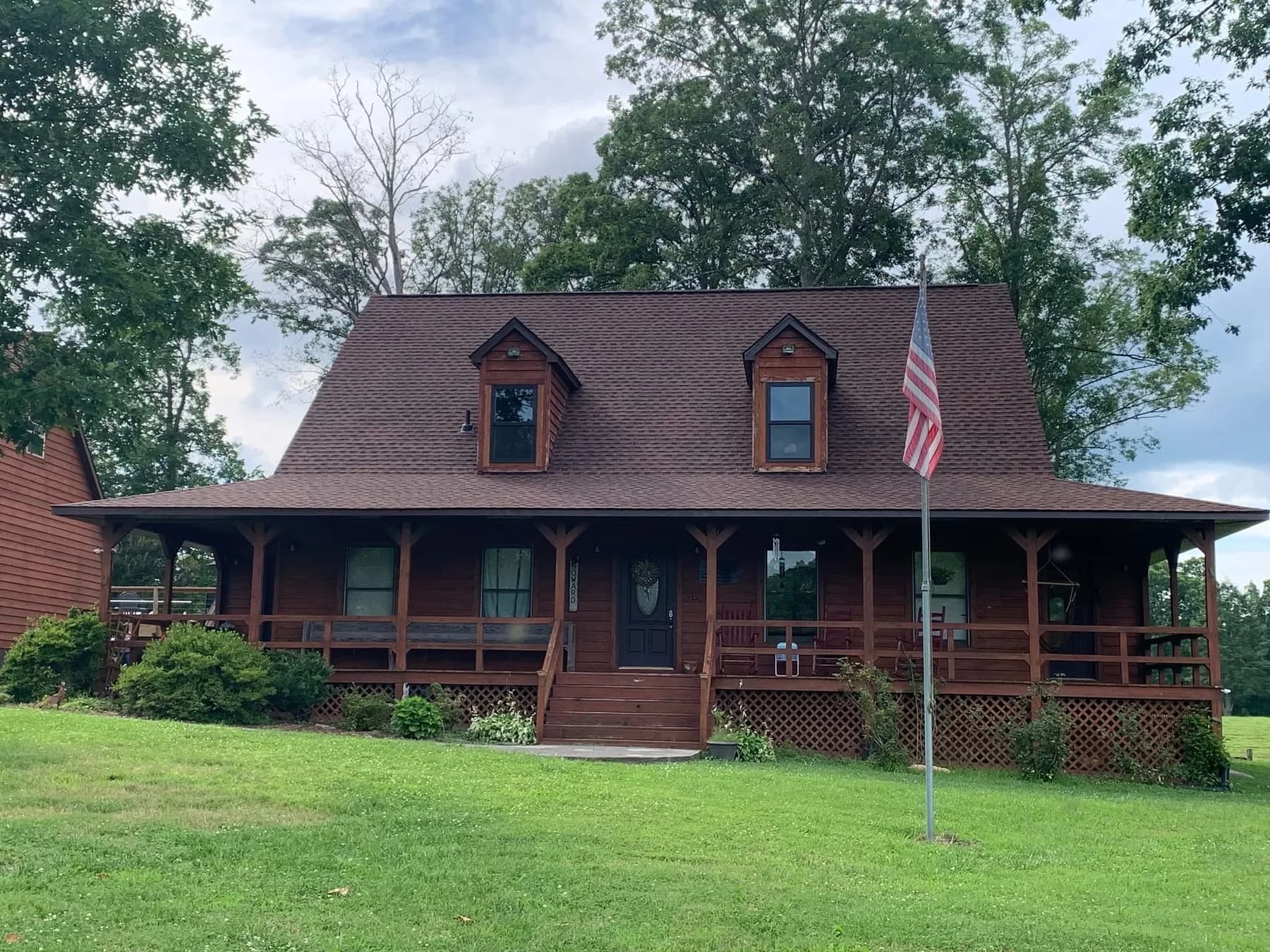 Cabin-style home with red metal roof